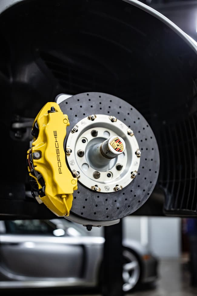Repasi Motorwerks technician preparing Carrera GT brake upgrade parts