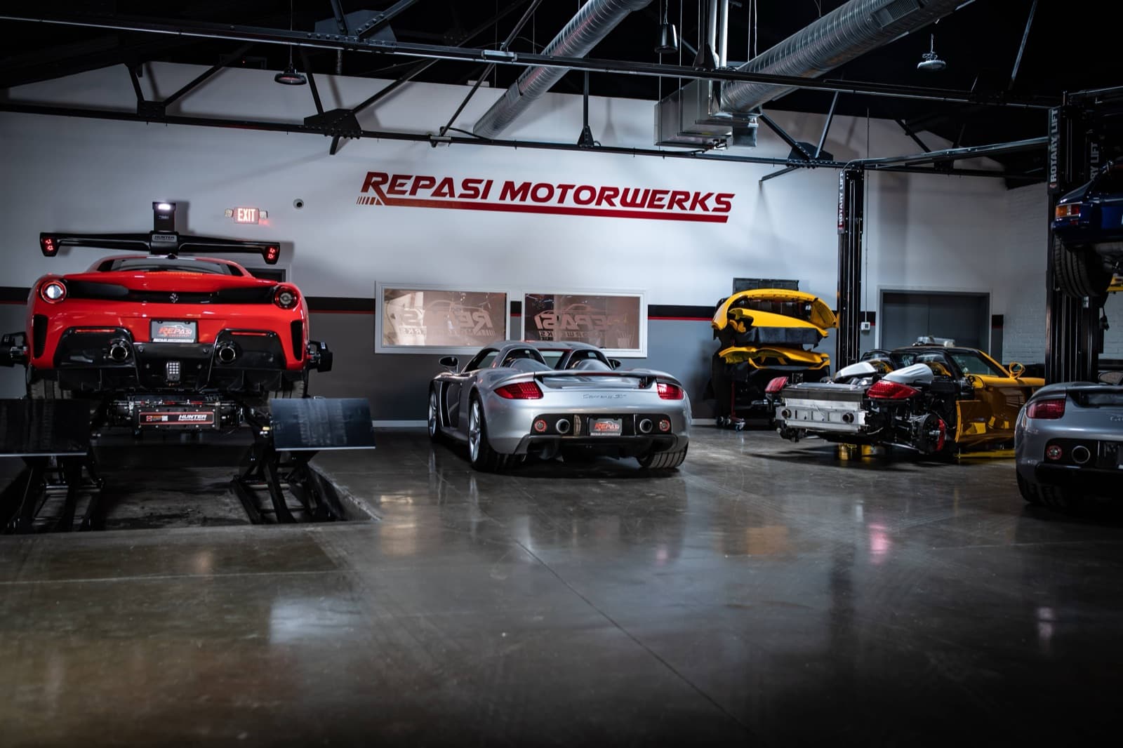 High-performance cars on lifts at Repasi Motorwerks service bay