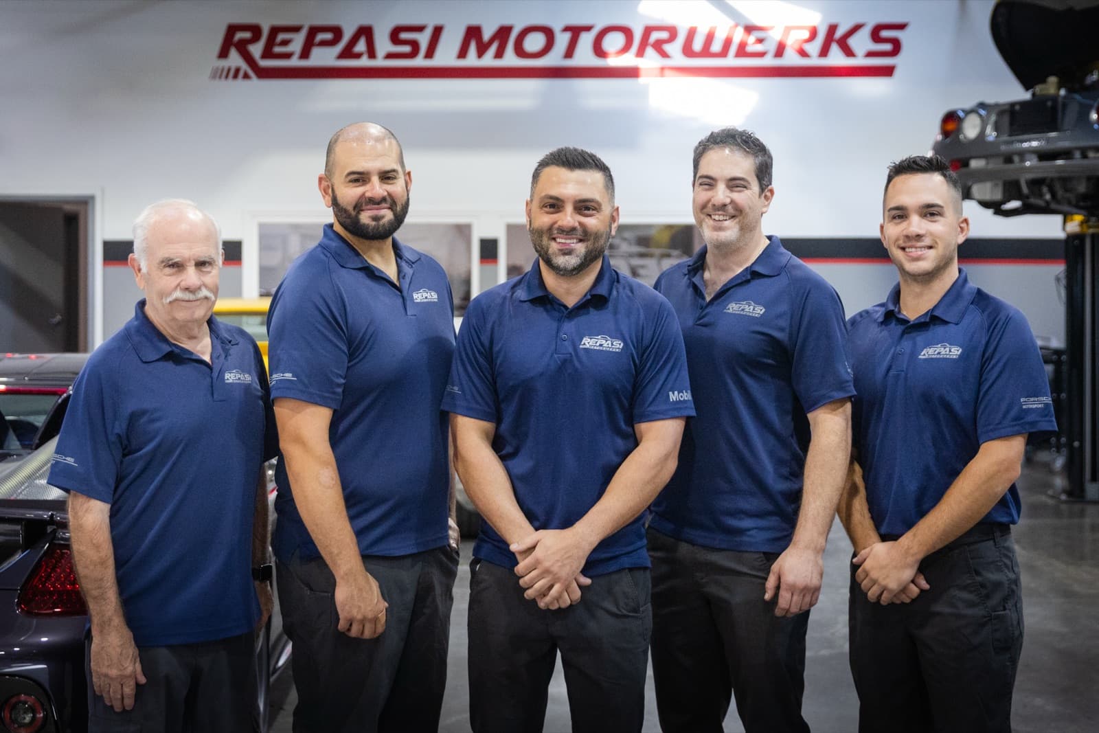 The Repasi Motorwerks team of five staff members in front of the shop