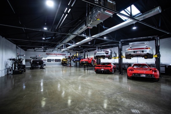 Wide shop floor at Repasi Motorwerks with multiple Carrera GTs on lifts